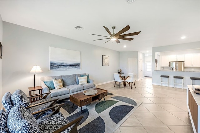 tiled living room featuring ceiling fan