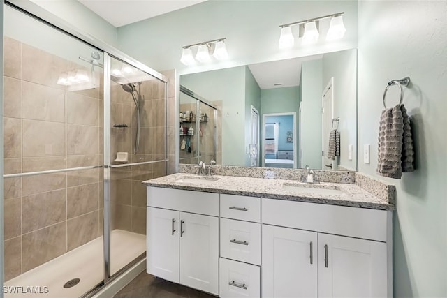 bathroom featuring an enclosed shower and vanity