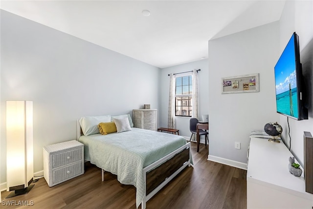 bedroom with dark wood-type flooring