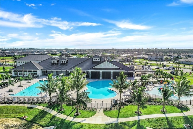 view of pool featuring a patio and a yard