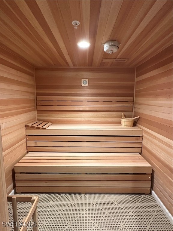 view of sauna with wood ceiling and wooden walls