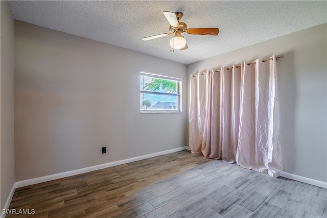 unfurnished room featuring wood-type flooring, a textured ceiling, and ceiling fan