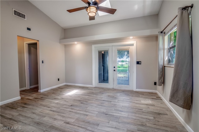 unfurnished room with ceiling fan, light wood-type flooring, and french doors