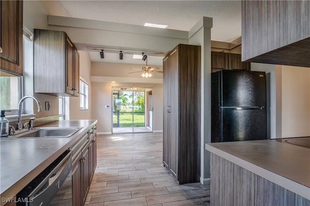 kitchen with light hardwood / wood-style floors, sink, ceiling fan, rail lighting, and black refrigerator