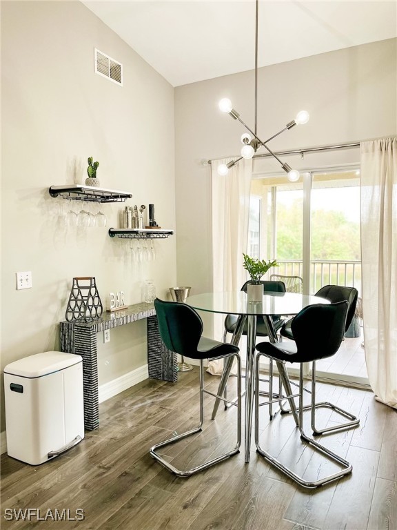 dining area featuring a chandelier and wood-type flooring