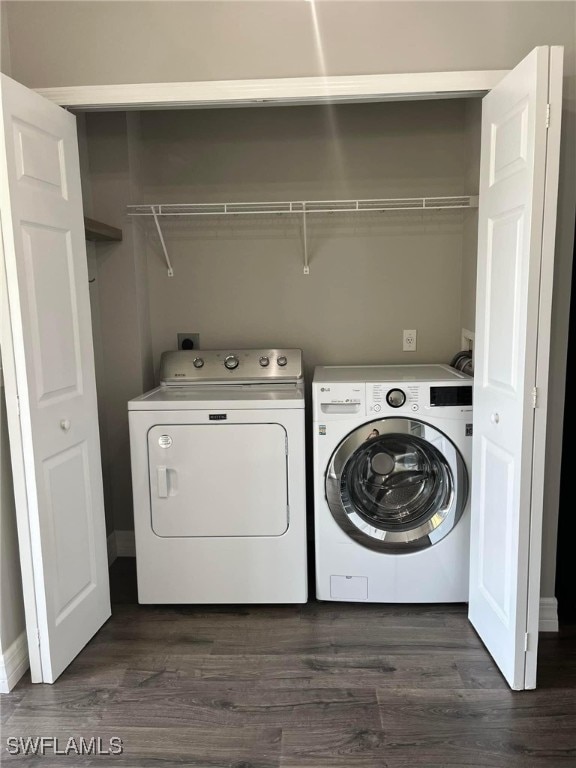 clothes washing area featuring separate washer and dryer and dark hardwood / wood-style flooring