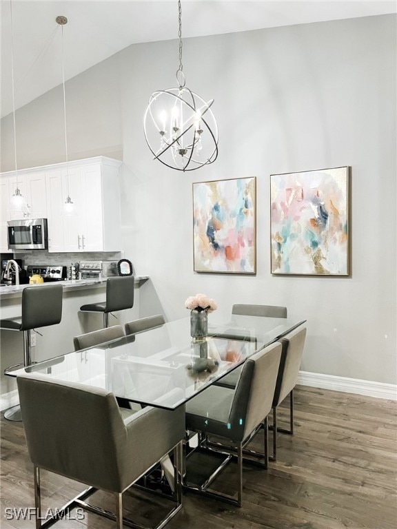 dining room featuring a chandelier, dark hardwood / wood-style floors, and high vaulted ceiling