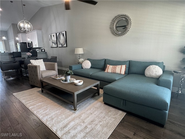 living room with hardwood / wood-style flooring, ceiling fan with notable chandelier, and high vaulted ceiling