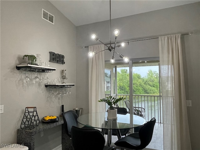 dining room with vaulted ceiling and an inviting chandelier