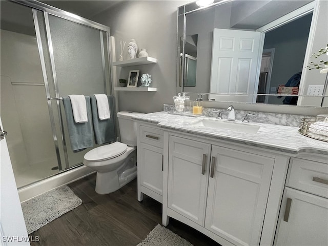 bathroom with vanity, hardwood / wood-style flooring, toilet, and walk in shower