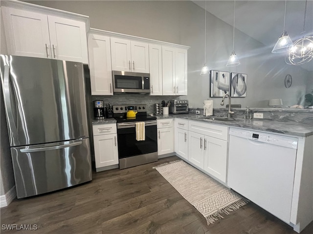 kitchen featuring white cabinets, sink, decorative light fixtures, dark hardwood / wood-style flooring, and stainless steel appliances