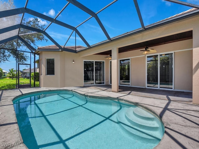 view of swimming pool with ceiling fan, a patio, and a lanai