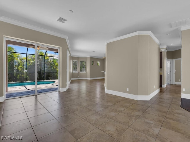 tiled spare room featuring ornamental molding