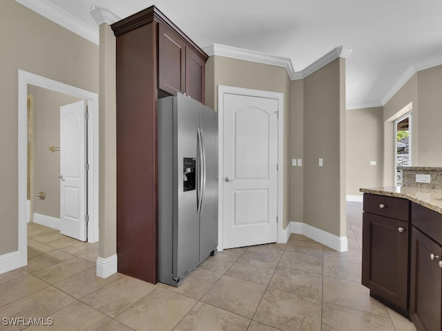 kitchen with dark brown cabinetry, light stone countertops, crown molding, and stainless steel fridge with ice dispenser