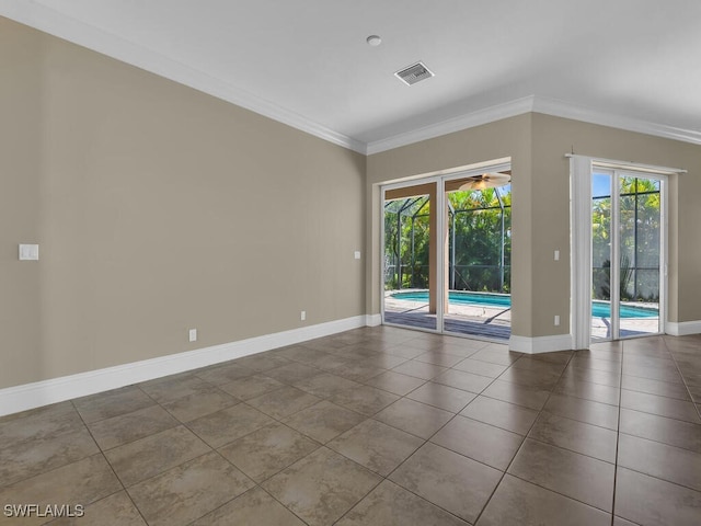 empty room with plenty of natural light, ornamental molding, and tile patterned flooring