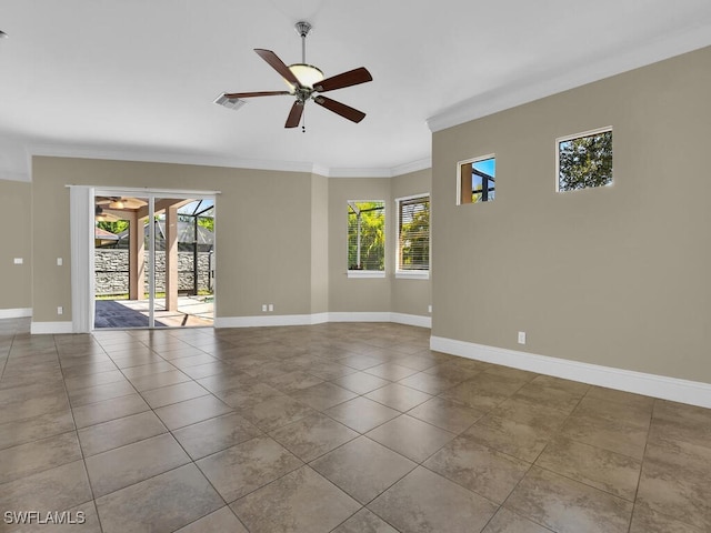 tiled empty room with ceiling fan and ornamental molding