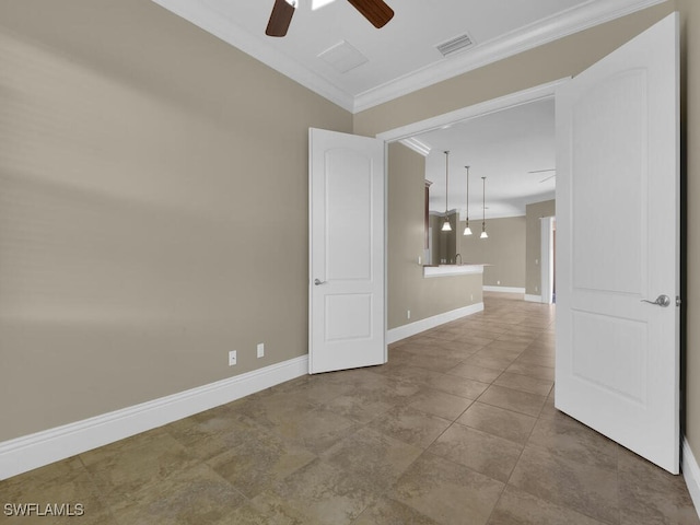 unfurnished room featuring ceiling fan and crown molding