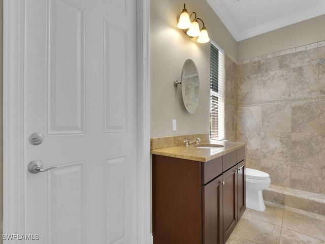 bathroom with tile walls, tile patterned flooring, vanity, and toilet