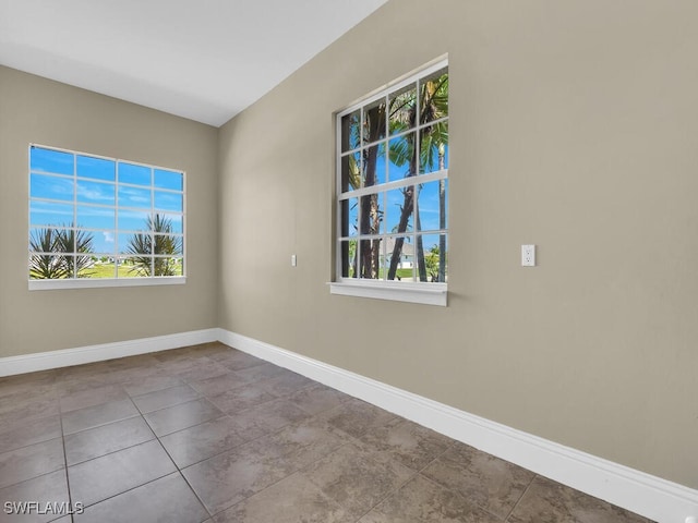 spare room with plenty of natural light and light tile patterned floors