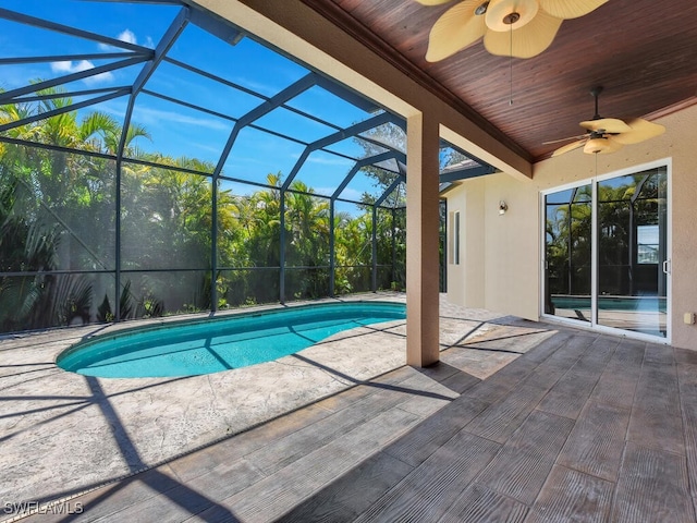 view of pool featuring a lanai, ceiling fan, and a patio area