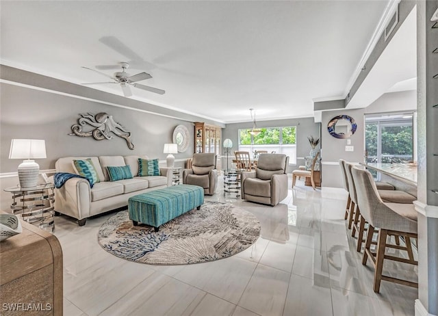 tiled living room featuring ornamental molding and ceiling fan