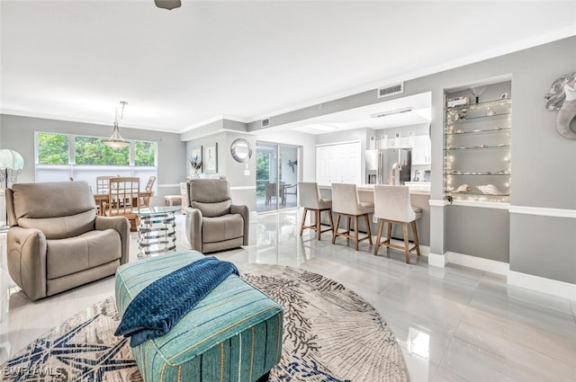 living room featuring light tile patterned flooring and crown molding