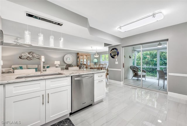 kitchen featuring hanging light fixtures, white cabinetry, light stone counters, dishwasher, and ceiling fan