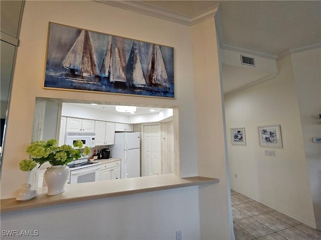 kitchen with white appliances, visible vents, white cabinetry, light countertops, and crown molding