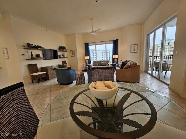 living area with ceiling fan, ornamental molding, and light tile patterned flooring