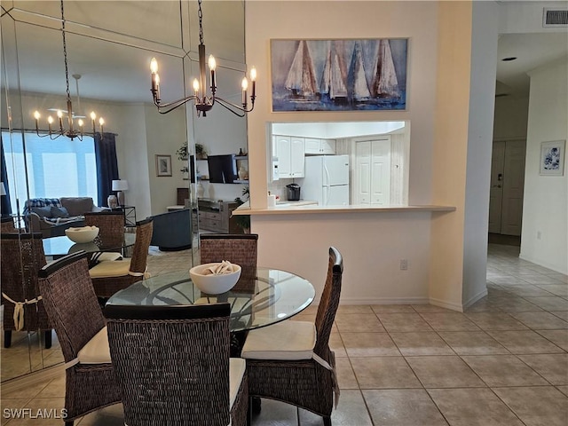 dining space featuring light tile patterned floors, visible vents, and a notable chandelier