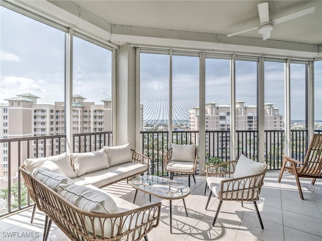 sunroom / solarium with a view of city, plenty of natural light, and a ceiling fan