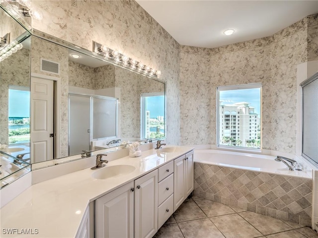 bathroom with visible vents, a stall shower, a sink, tile patterned flooring, and wallpapered walls