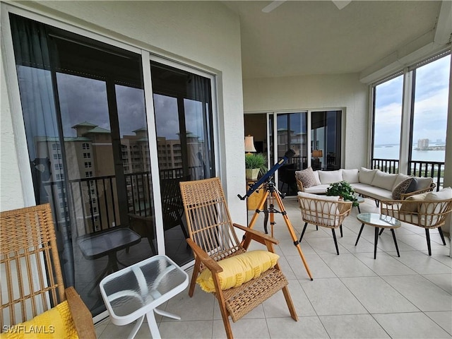 sunroom / solarium featuring a water view