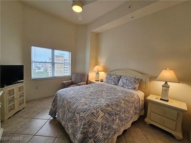 bedroom featuring tile patterned flooring, baseboards, and ceiling fan