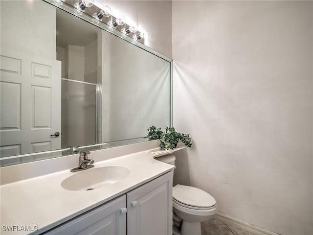 full bathroom featuring a stall shower, vanity, toilet, and tile patterned floors