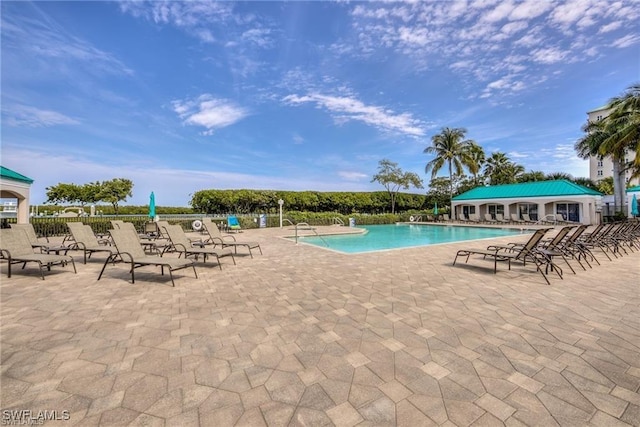 community pool featuring a patio and fence