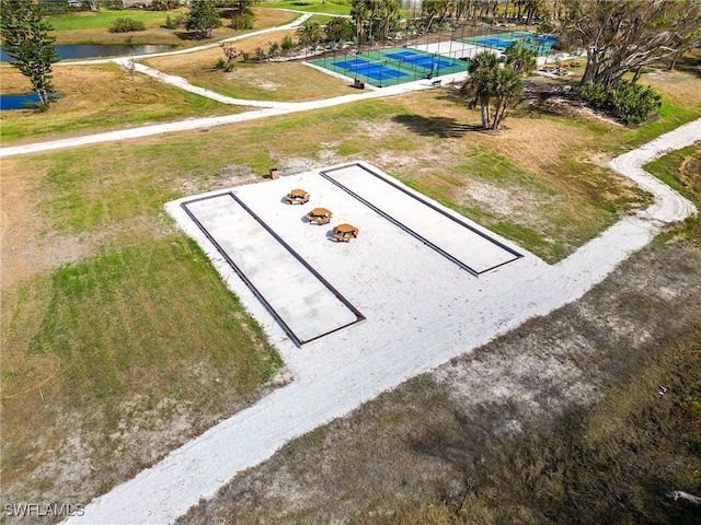 view of storm shelter featuring a water view and a yard