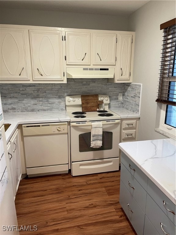 kitchen featuring white cabinets, white appliances, ventilation hood, dark hardwood / wood-style floors, and decorative backsplash