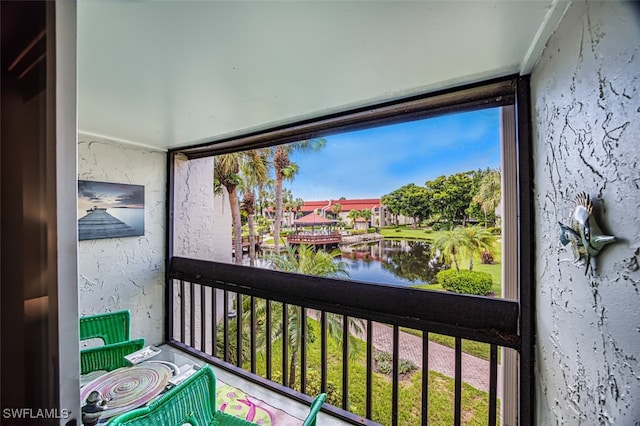 balcony featuring a water view