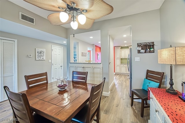 dining room featuring light wood-type flooring and ceiling fan