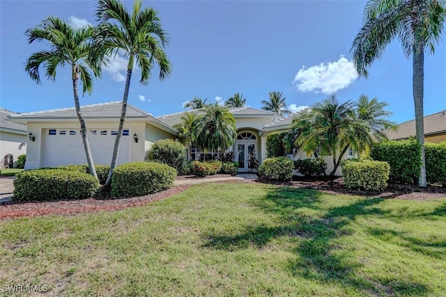 view of front of house featuring a garage and a front yard