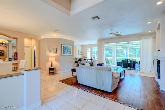 living room with light hardwood / wood-style flooring and ceiling fan