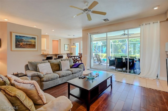 living room featuring hardwood / wood-style floors and ceiling fan