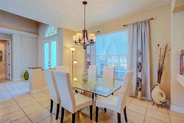 tiled dining space featuring a notable chandelier