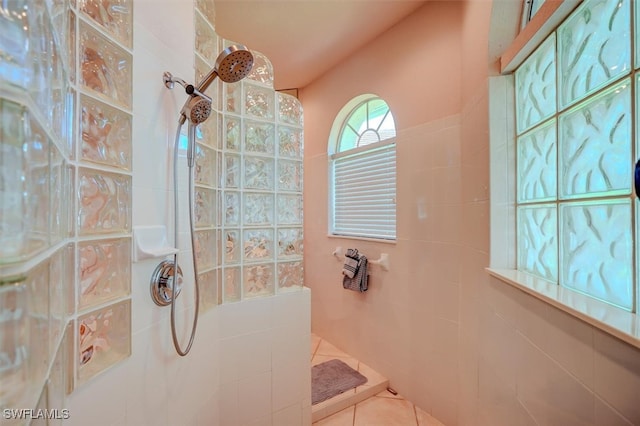 bathroom with walk in shower and tile patterned flooring