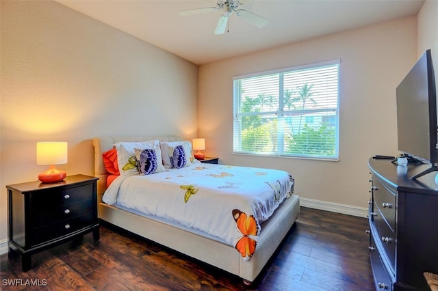 bedroom with dark hardwood / wood-style flooring and ceiling fan