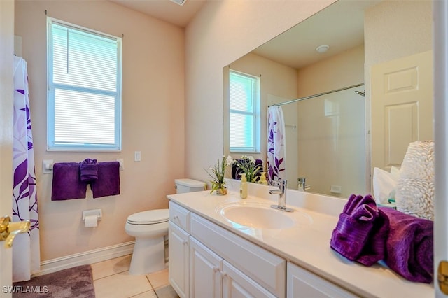 bathroom featuring vanity, tile patterned floors, toilet, and a healthy amount of sunlight