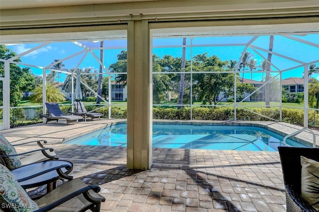 view of swimming pool with a patio and glass enclosure