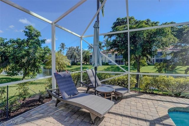 sunroom / solarium with a water view