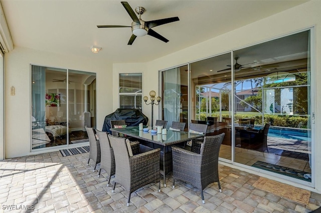 sunroom / solarium featuring ceiling fan